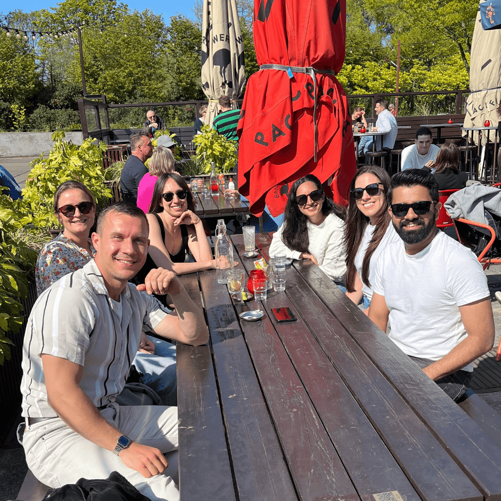 diverse group of young people laughing and having fun together at a cafe